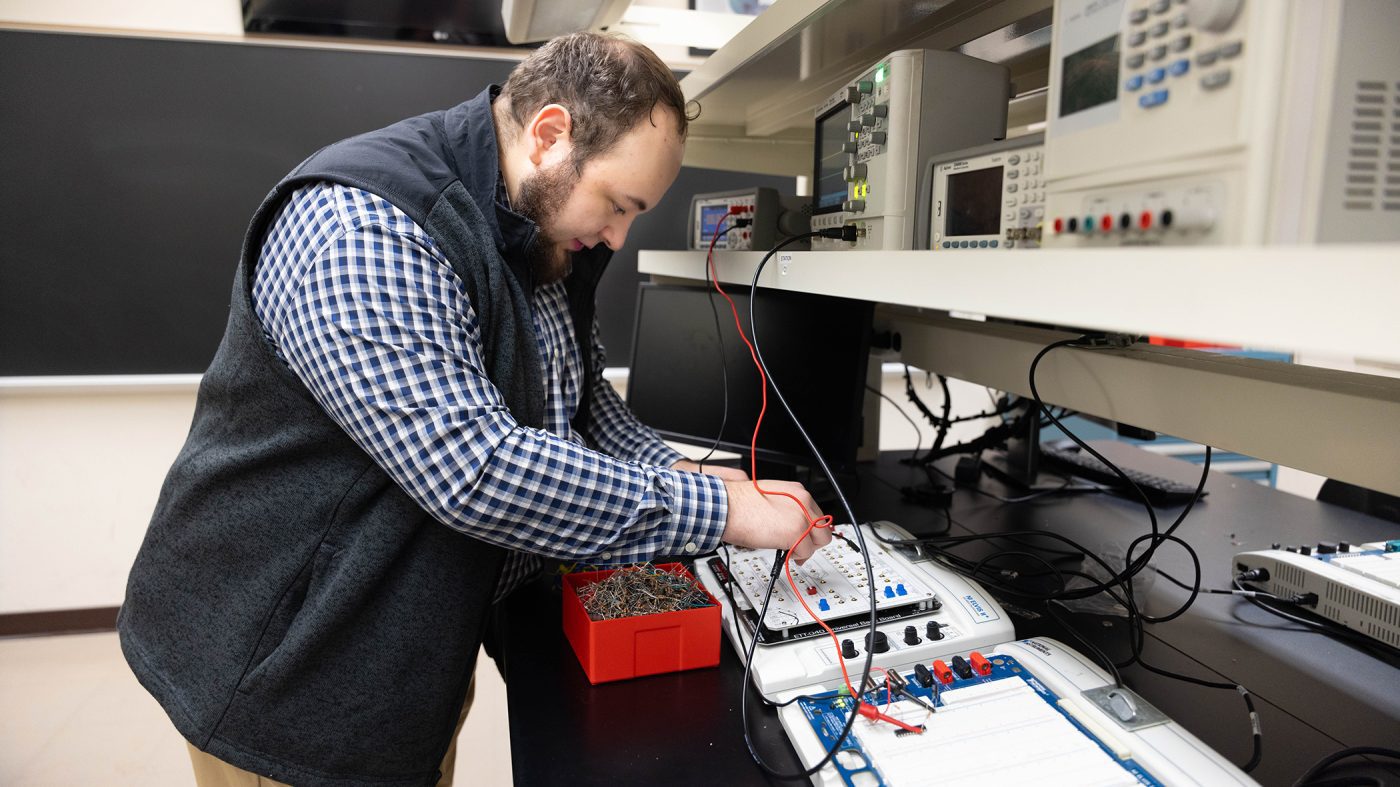 Graduate student working on electrical engineering project